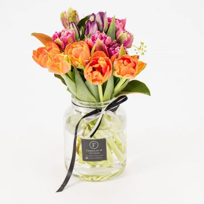 Orange and purple tulips in a clear glass jar with black grosgrain ribbon and studio F-tag — Luscious Embers